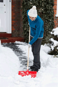 snow shoveling bill -- photo of person shoveling snow from walkway of a home