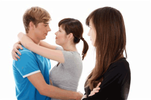 Cohabitation: Photo of couple embracing with woman looking on