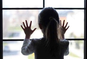 Child custody -- photo of girl with her back to camera staring out window