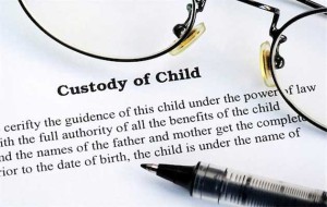 Joint Custody -- photo of pen and corner of eyeglasses lying on a Child Custody agreement