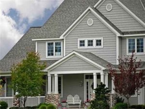 Property Distribution: Photo of gray house with white trim with double Adirondack chair on porch