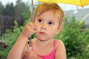 divorce precautions - photo of young girl in pink top holding yellow umbrella