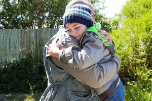 photo of child and parent hugging representing successful co-parenting efforts