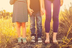 How to tell kids of all ages about divorce; photo of legs of three kids, different ages